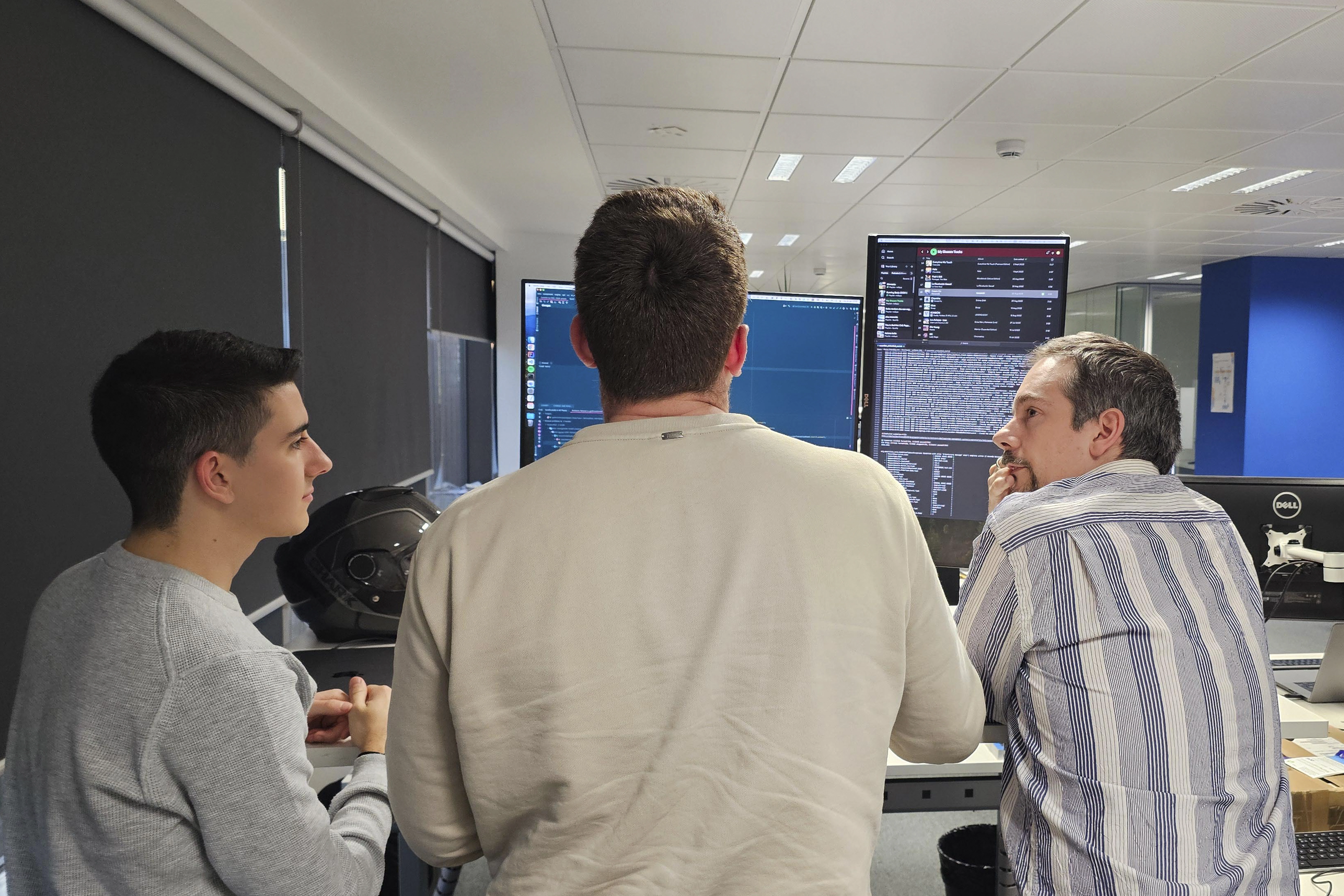 Three men working together at Adaptive