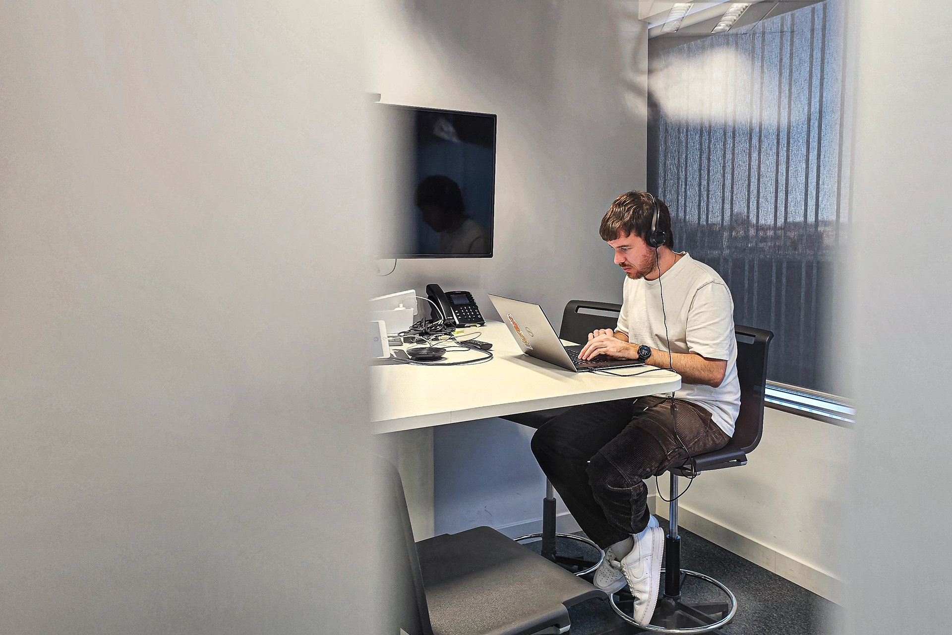 A man working from a meeting room at Adaptive