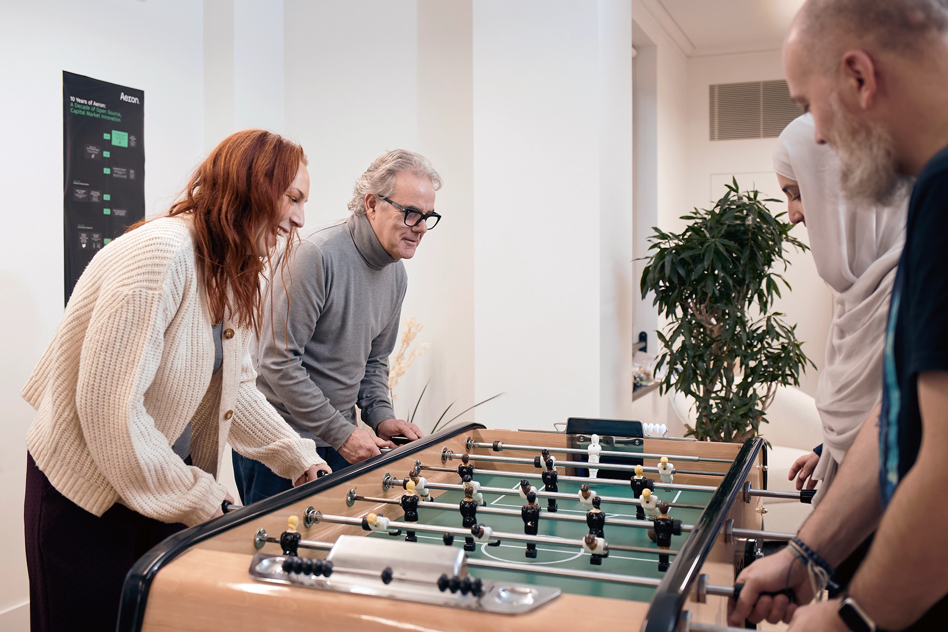 Group of people working foosball at Adaptive