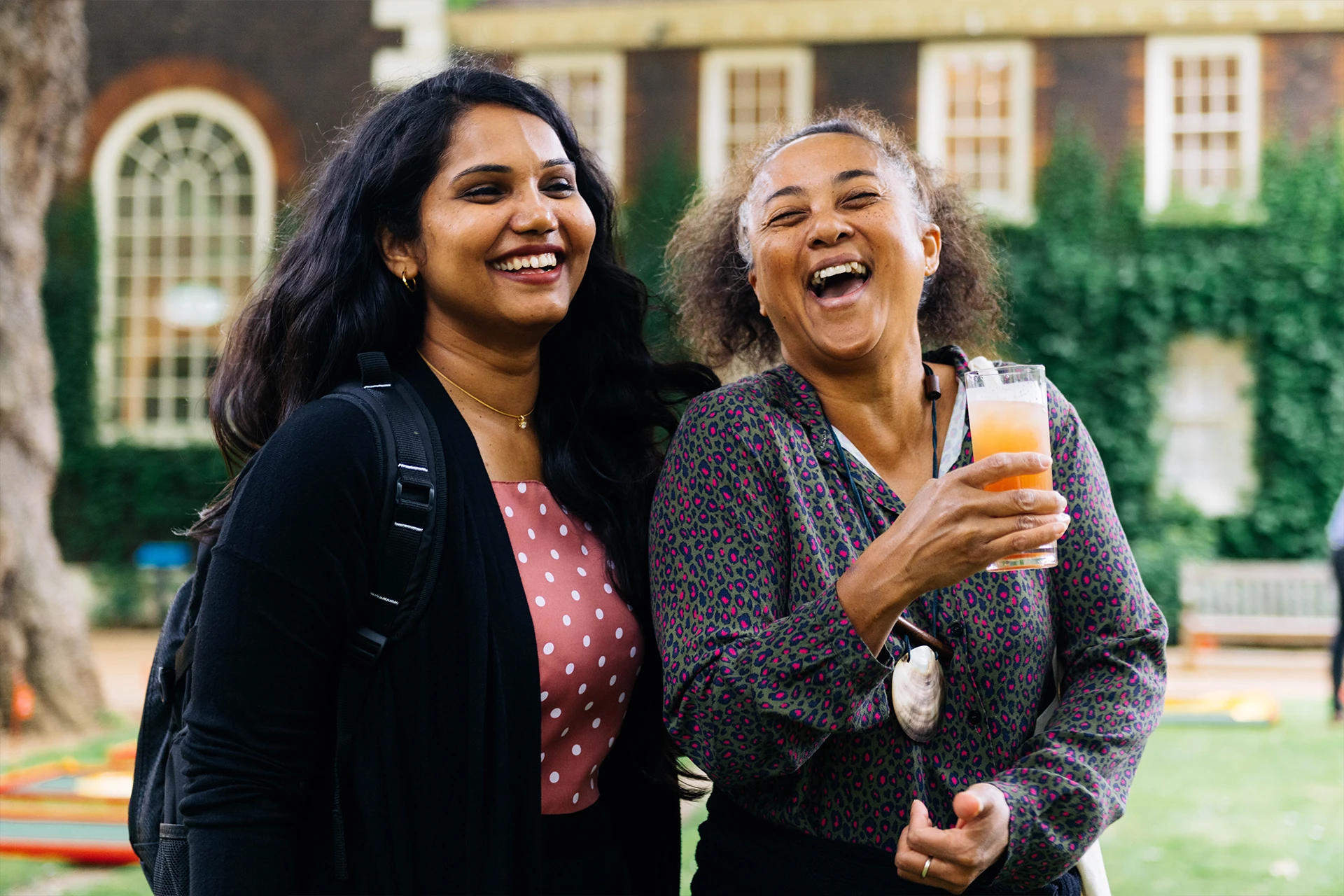 Two women laughing at Adaptive's party