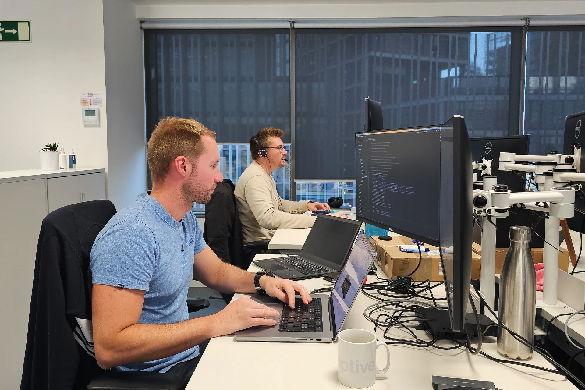 Two men working at their computers at Adaptive