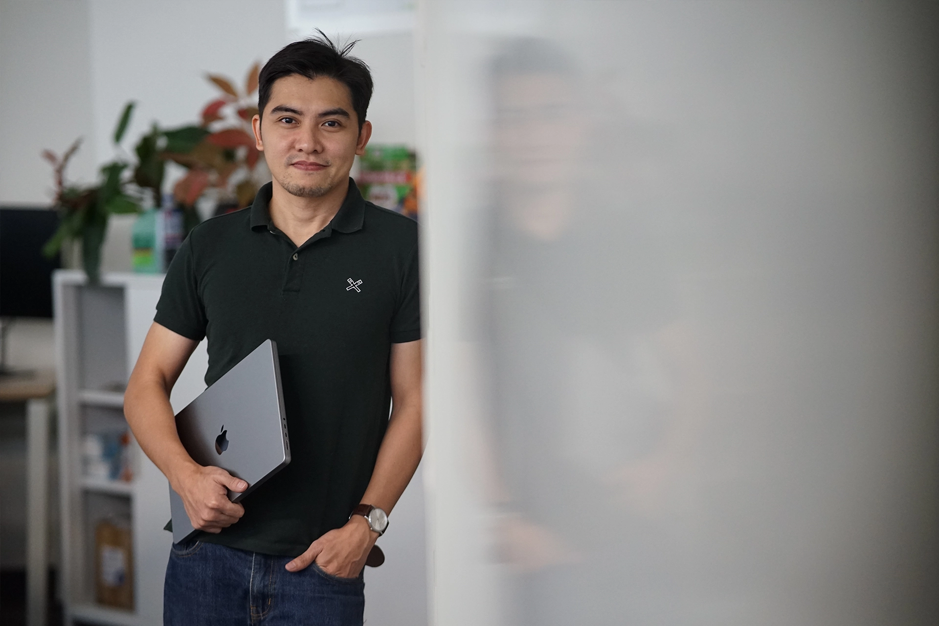 A man is standing at one of Adaptive's offices